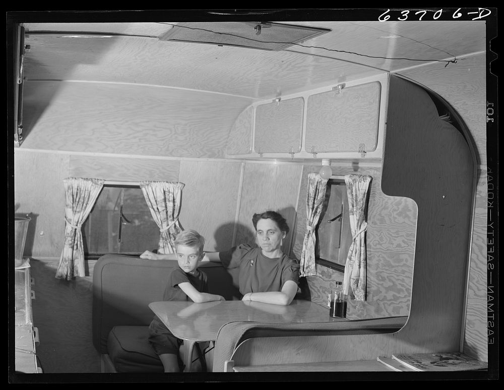 Mrs. Nichols, wife of defense worker, and son, in their trailer home at Edgewater Park near Ypsilanti, Michigan. They are…