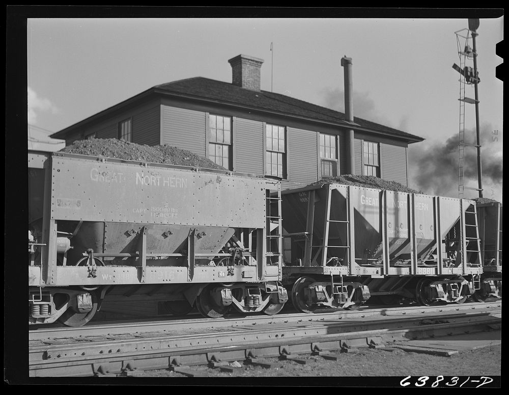 At Great Northern Railroad yards, cars of iron ore passing over the scales are weighed at the rate of three and a half a…