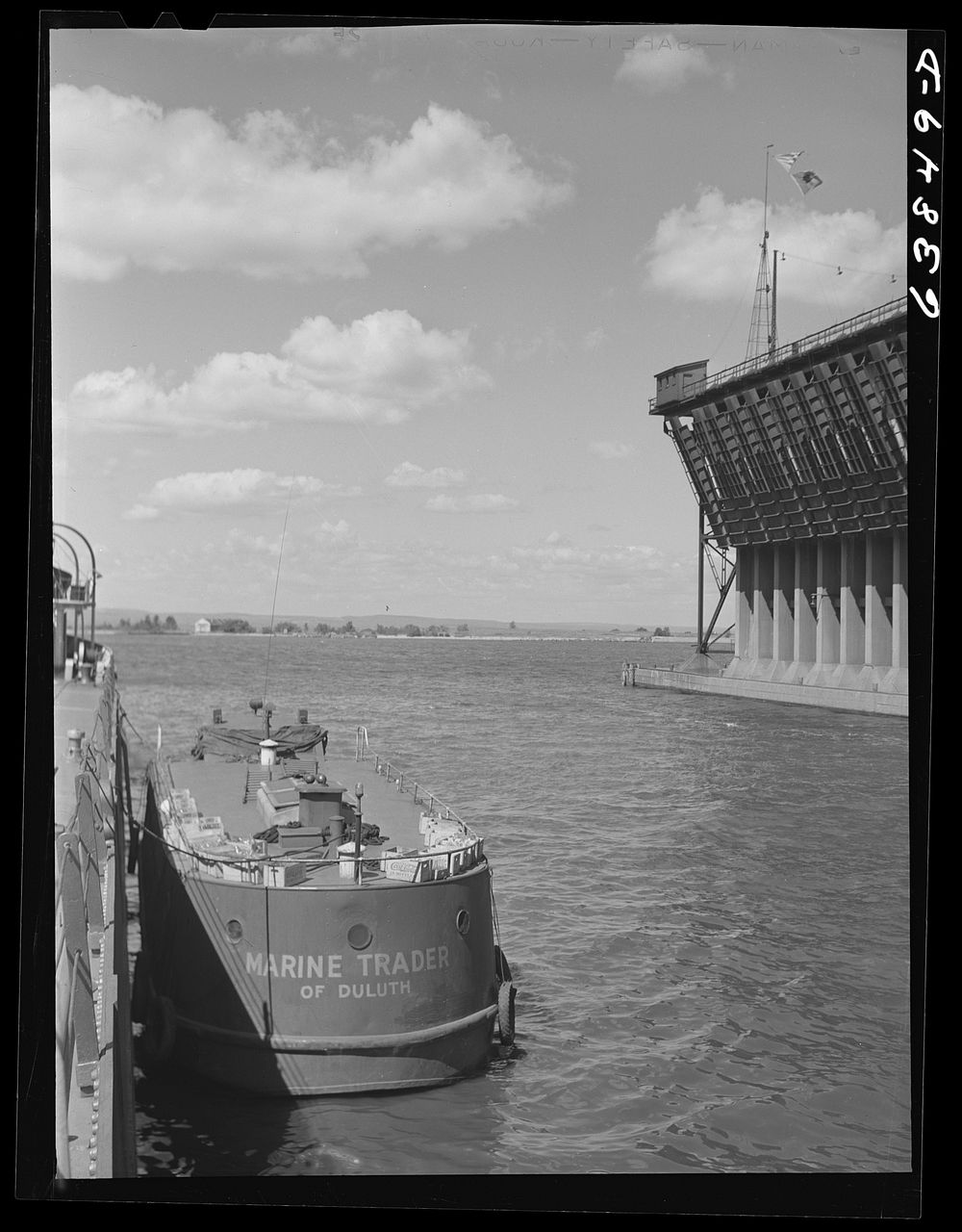 Floating laundries and general stores pull up alongside of boats which may be in port only a few hours. Allouez, Wisconsin.…