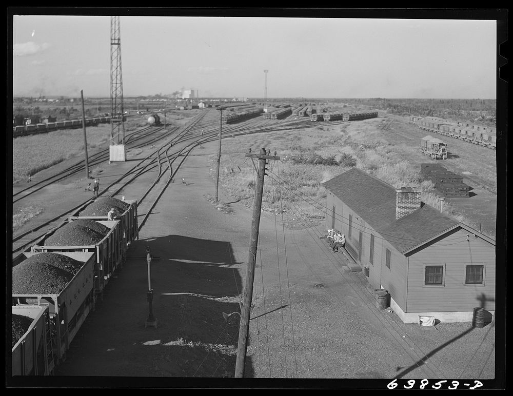 [Untitled photo, possibly related to: Cars of iron ore passing through the scales at Great Northern Railroad yards.…