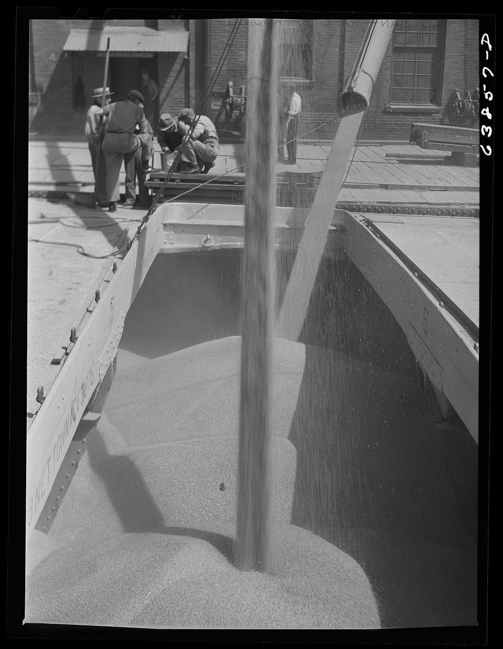 Loading grain into hold of Great Lakes boat. Superior, Wisconsin. Sourced from the Library of Congress.