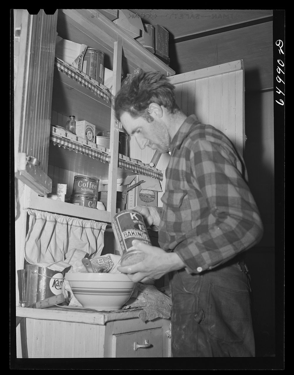 Garfield County, Montana. Sheepherder making biscuits in his winter quarters. Sourced from the Library of Congress.