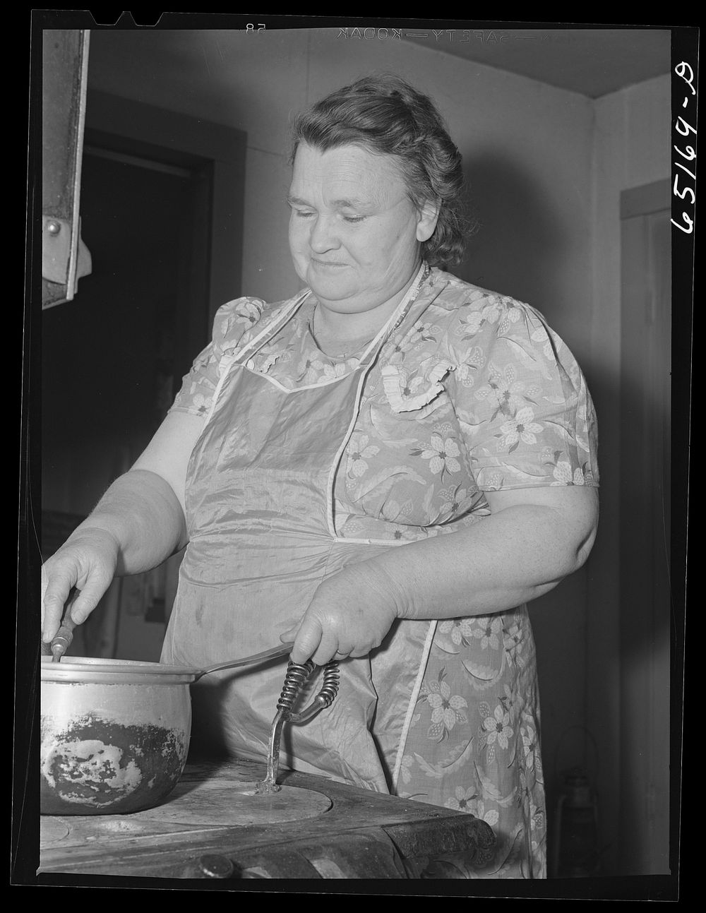 Flathead Valley special area project, Montana. Mrs. James Doyle at her kitchen stove. The Doyles are FSA (Farm Security…