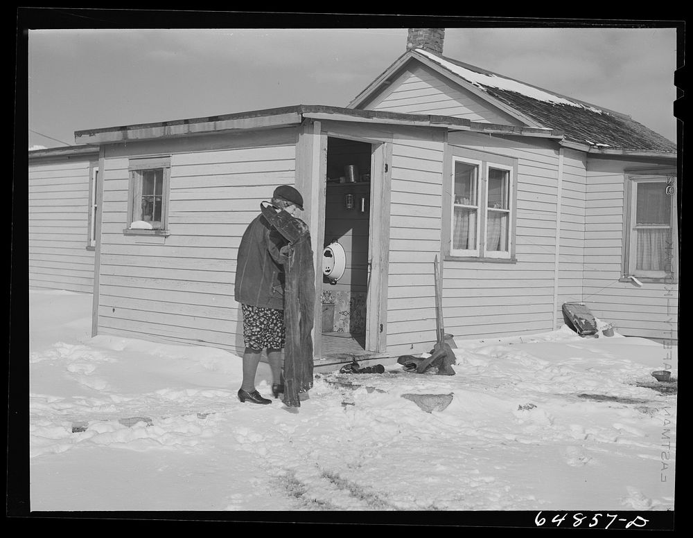 [Untitled photo, possibly related to: Adams County, North Dakota. Mrs. Lee Johnson bringing in a pair of overalls which had…