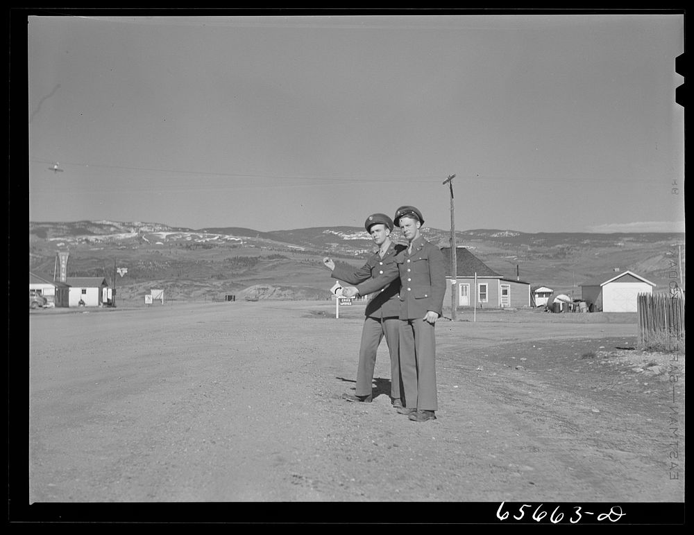Soldiers from Fort Logan, Colorado hitchhiking along U.S. highway number forty. Sourced from the Library of Congress.