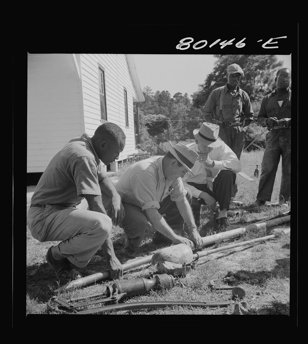 FSA (Farm Security Administration) engineer screws together well casing. Ridge well project, Saint Mary's County, Maryland.…