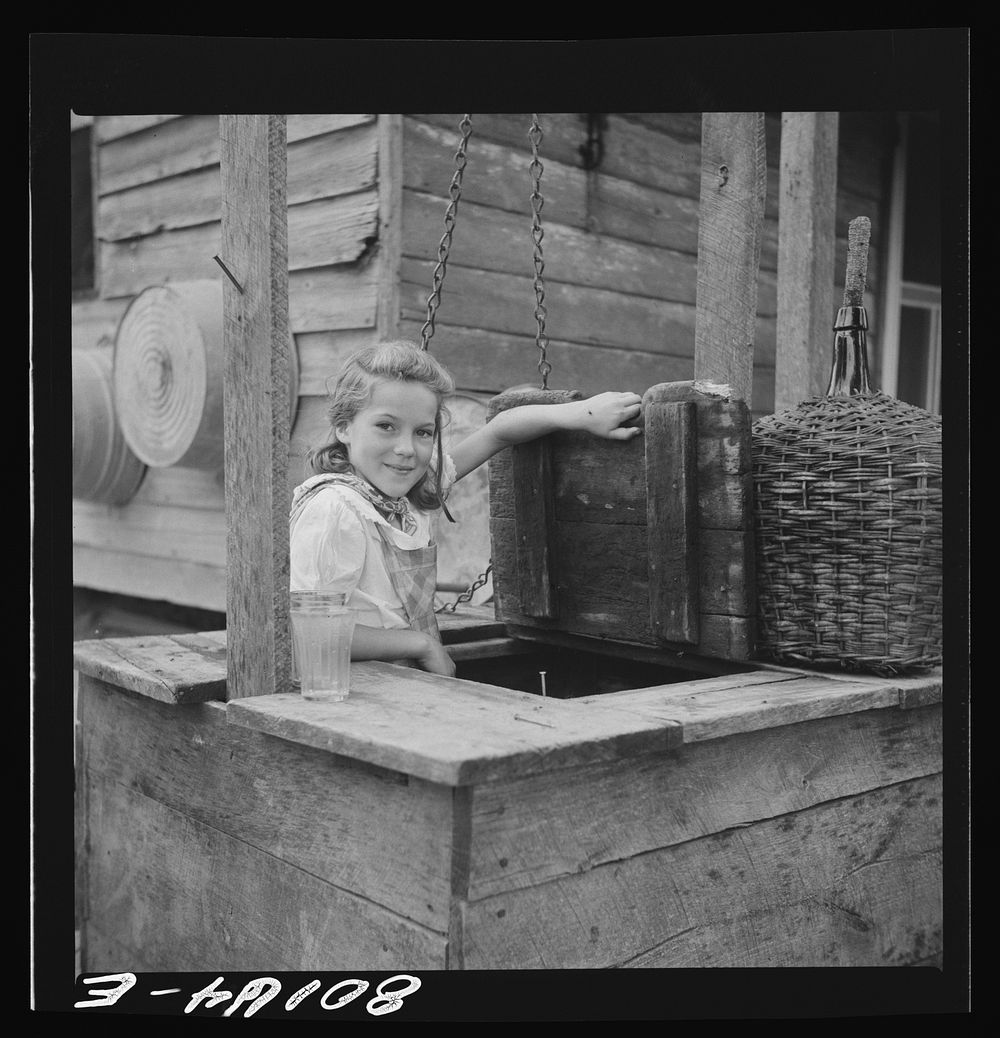 Daughter of John Hardesty made a playhouse out of old well top. Charles County, Maryland. Sourced from the Library of…