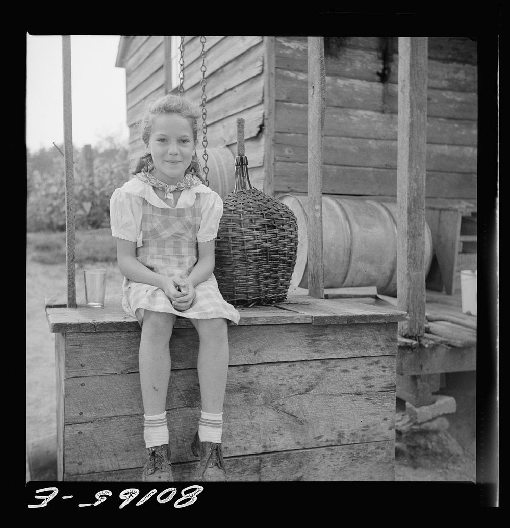 [Untitled photo, possibly related to: Daughter of John Hardesty made a playhouse out of old well top. Charles County…