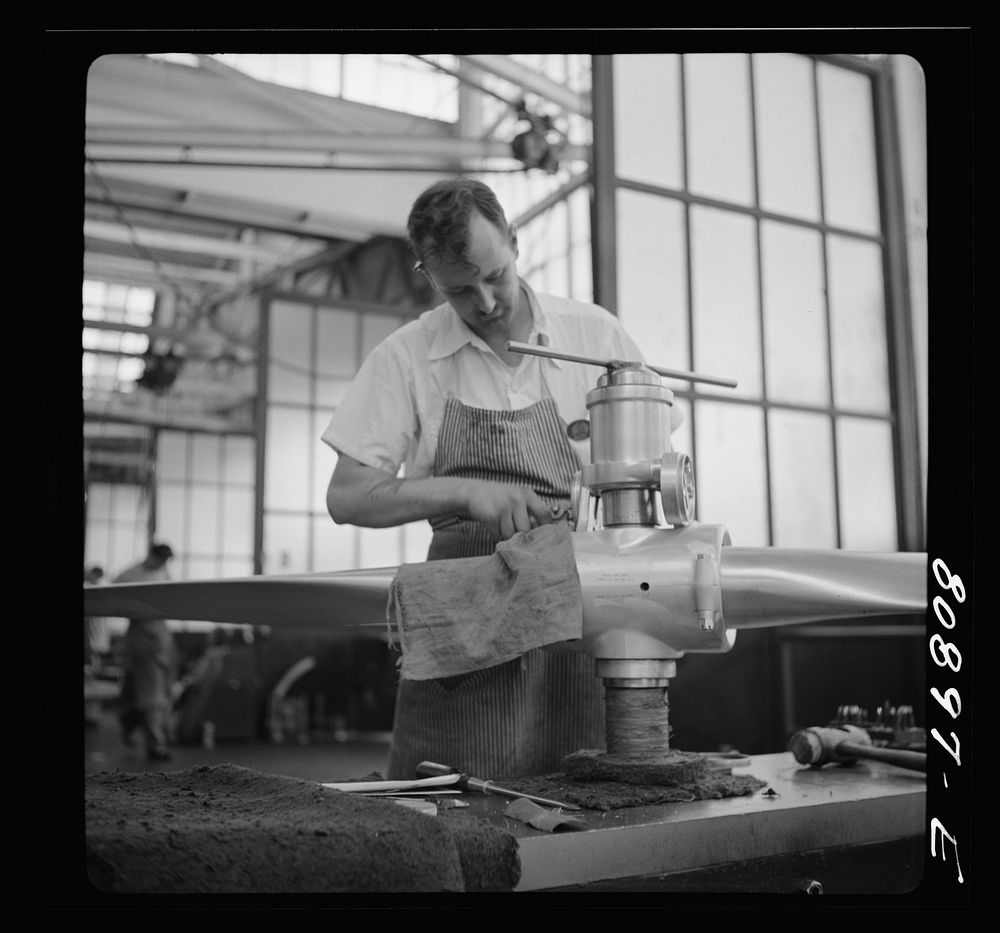 [Untitled photo, possibly related to: Final adjustment on finished propeller. Hamilton propeller plant, East Hartford…