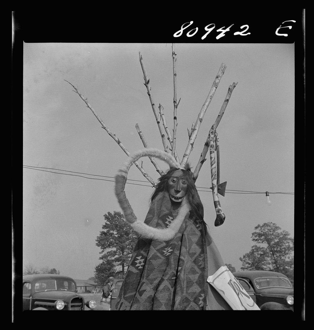Head of wigwam decorated with Indian dancing mask (Woods Indian). Local Indian association-sponsored Indian bazaar and fair.…