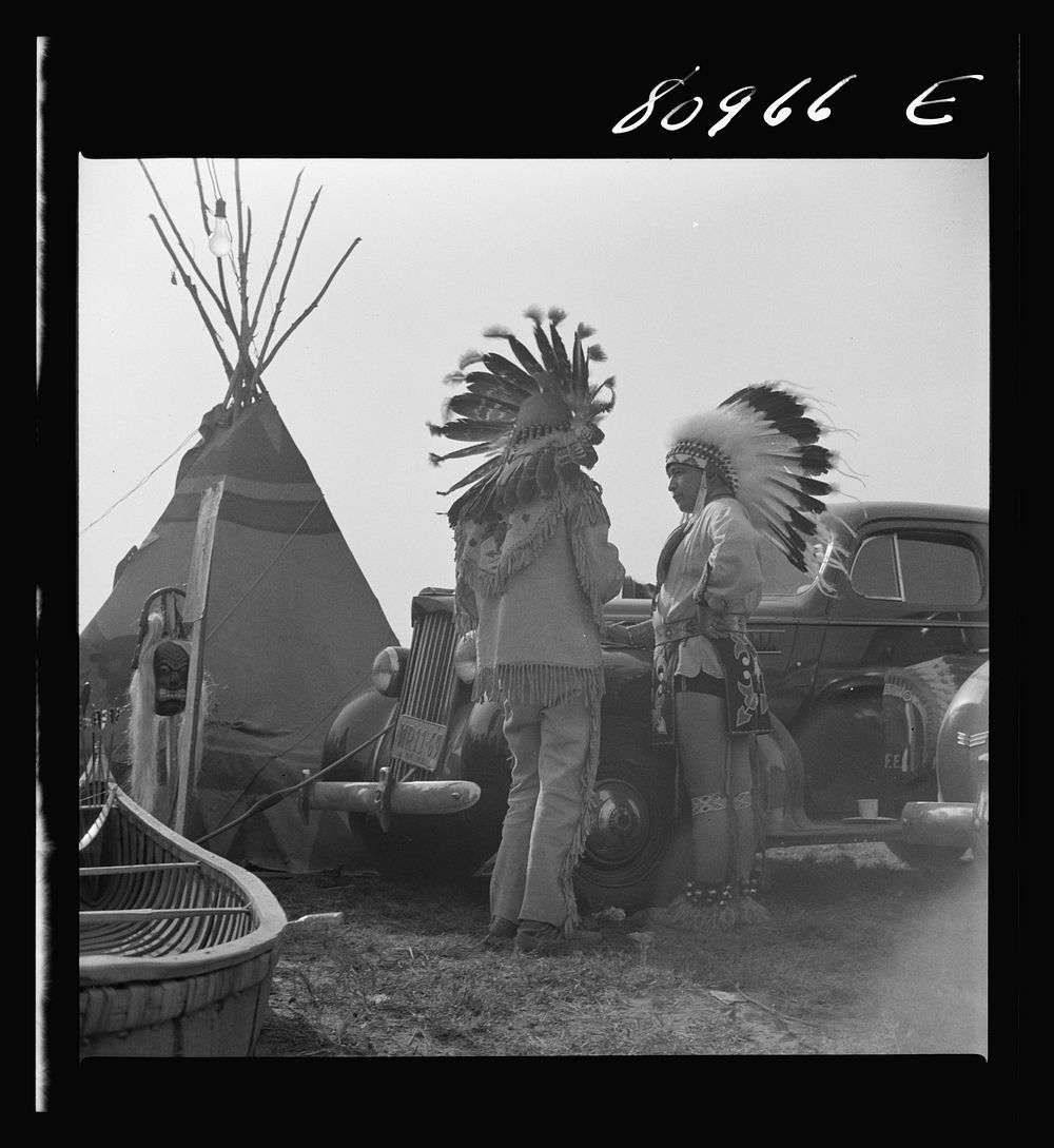 Windsor Locks, Connecticut. Two Indians standing by their car on the ground of the Indian fair sponsored by the local Indian…