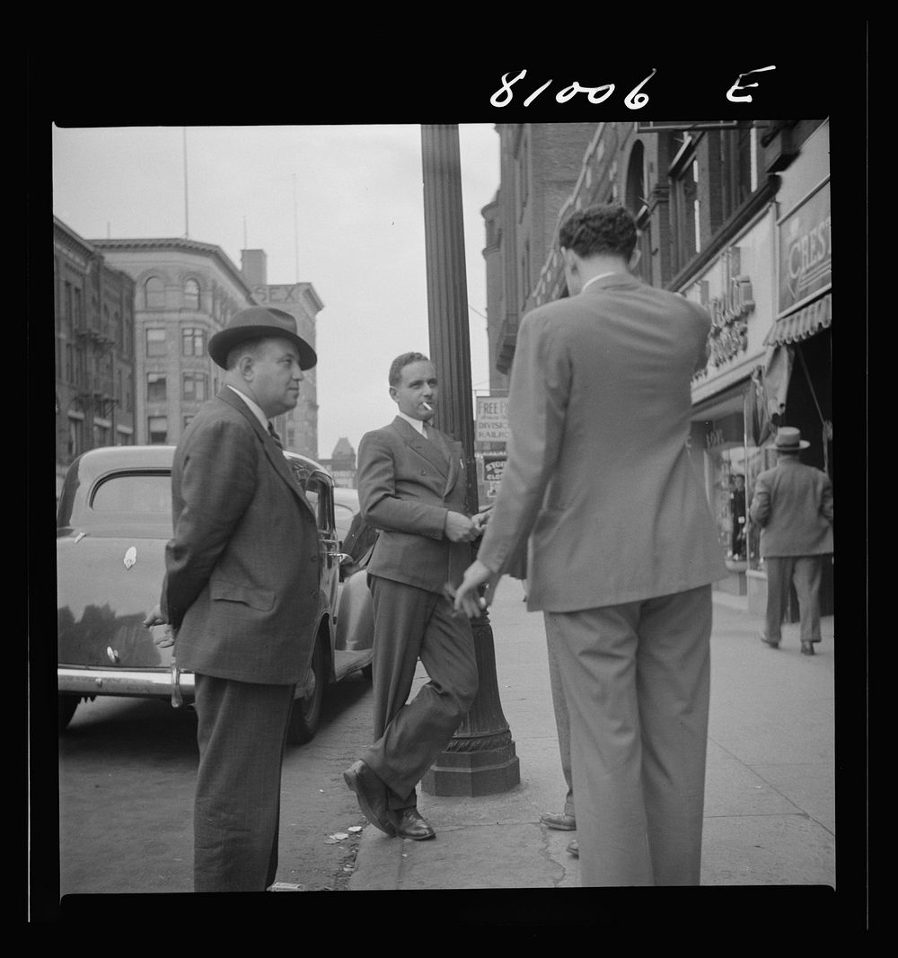 Men talk. Street scene at Holyoke, Massachusetts. Sourced from the Library of Congress.