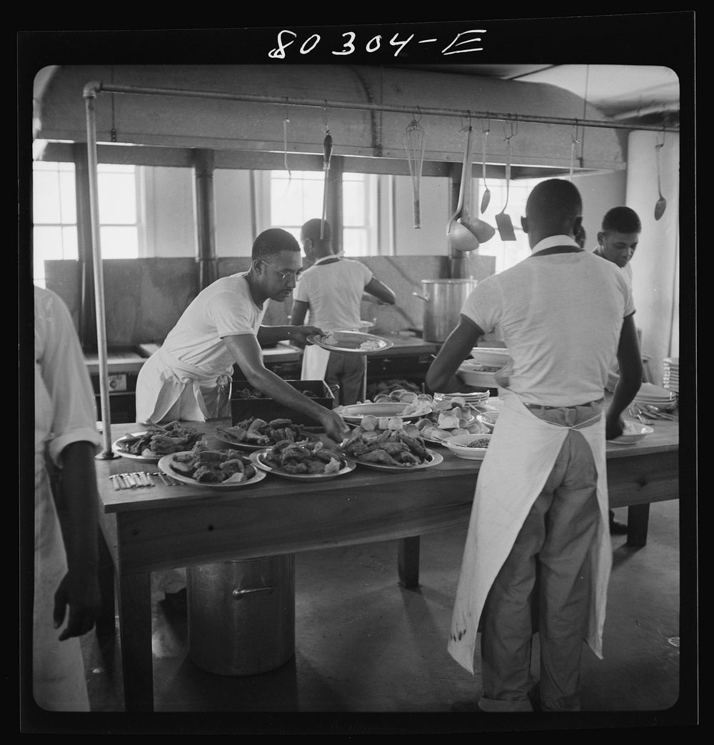 Craig Field cooks loading up platters of crisp fried chickens, supplied through the FSA (Farm Security Administration) "Food…