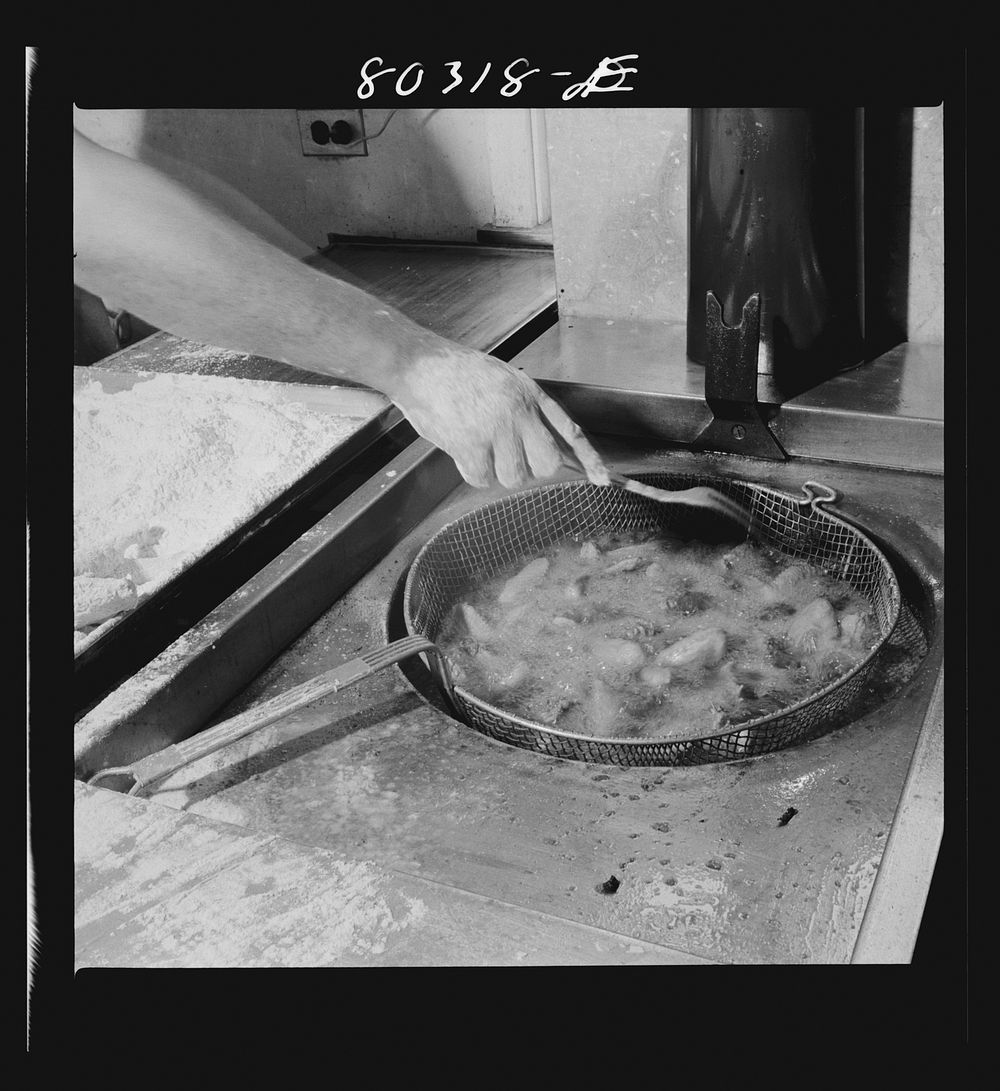 Sizzling in deep fat, FSA (Farm Security Administration) "Food for Defense" chickens for the Craig Field flying cadets'…