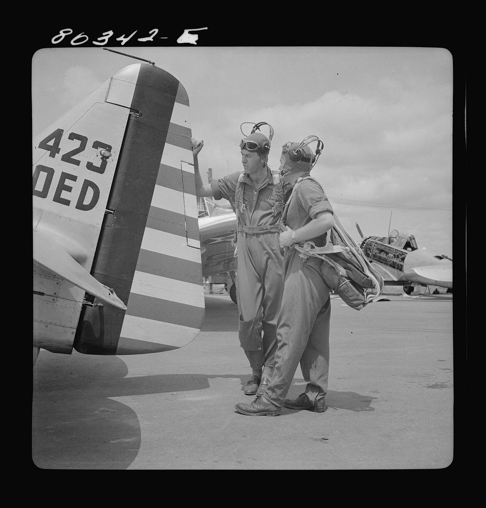 Flight instructors McTaggart and Gumison talk things over. Craig Field, Southeastern Air Training Center, Selma, Alabama.…