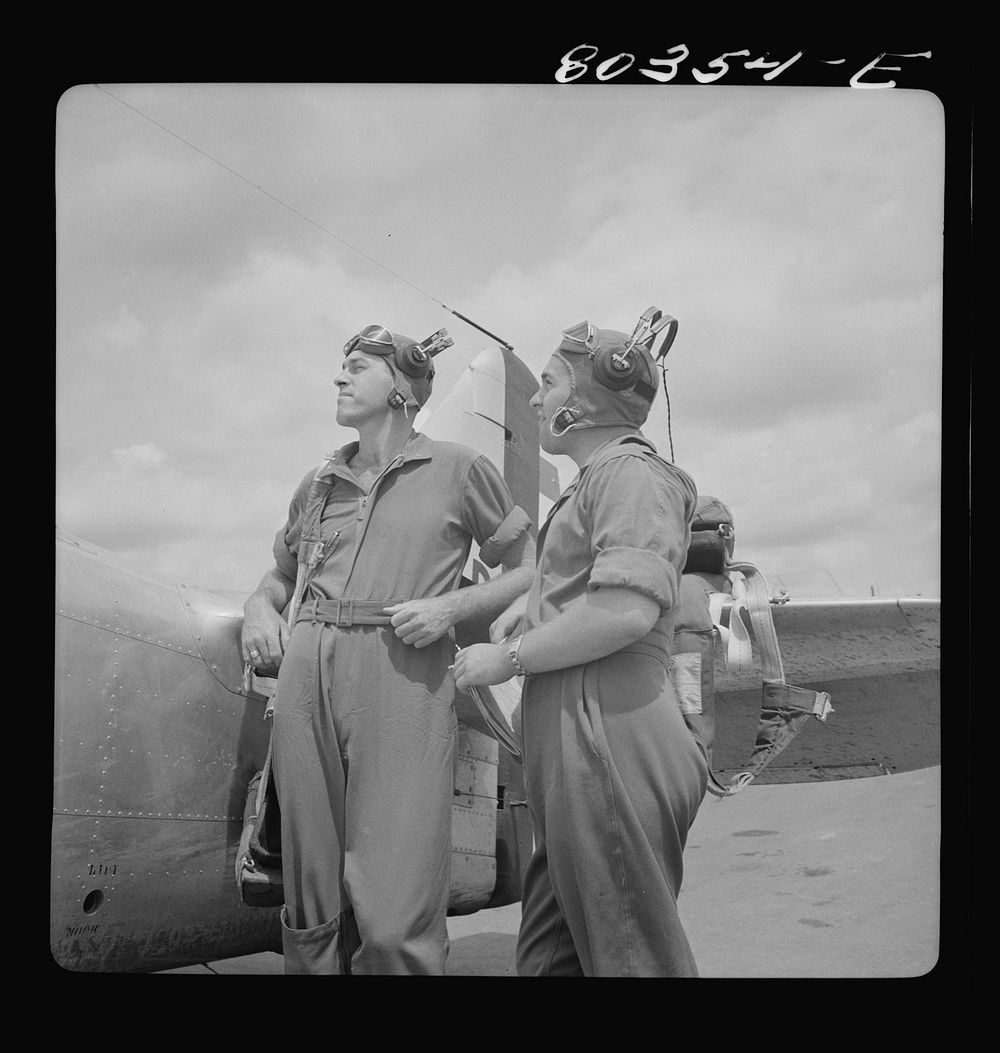 [Untitled photo, possibly related to: Flight instructors McTaggart and Gumison chart the afternoon flight after dinner of…