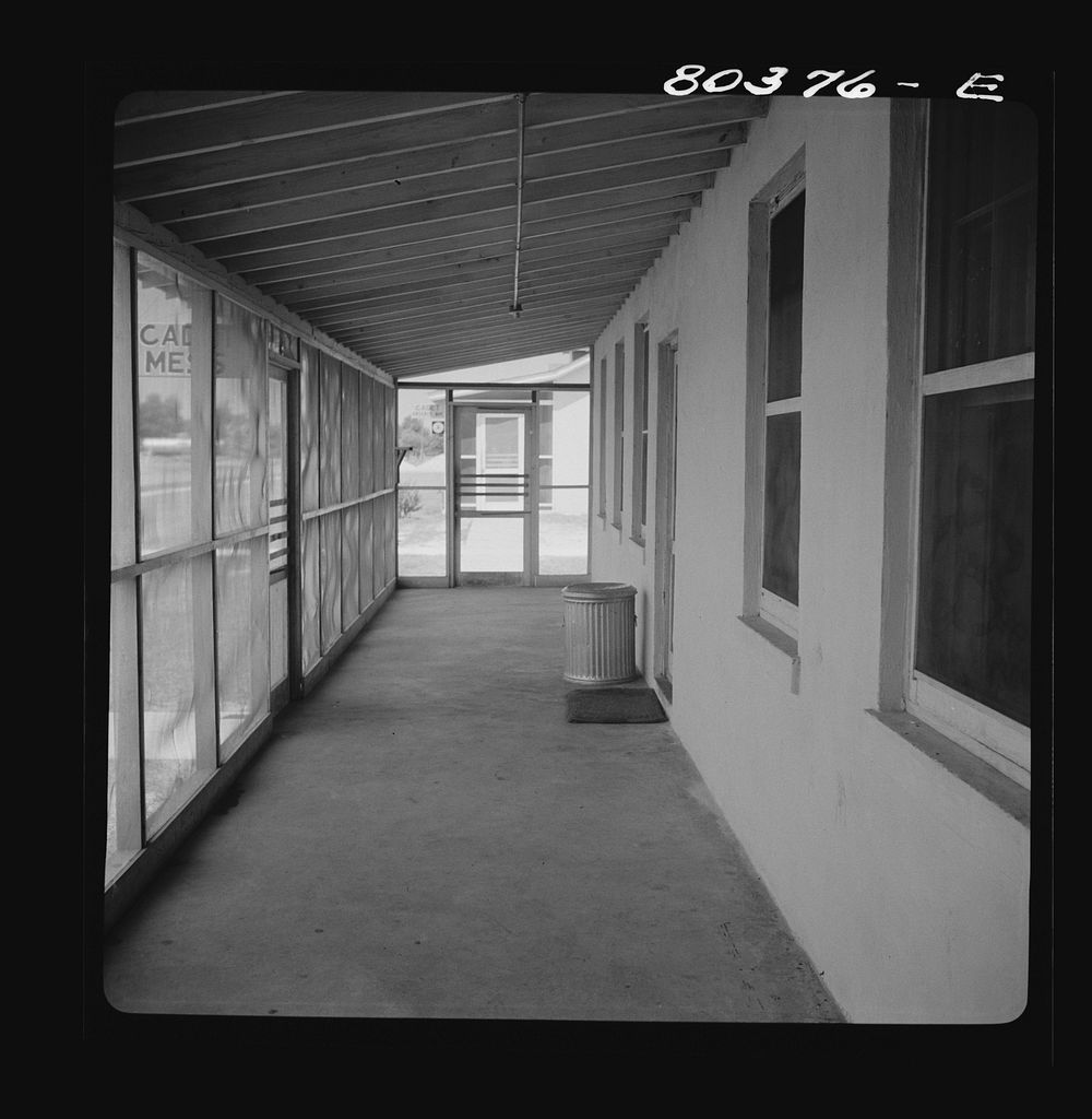 Porch running length of kitchen and cadets' mess. Craig Field, Southeastern Air Training Center, Alabama. Sourced from the…