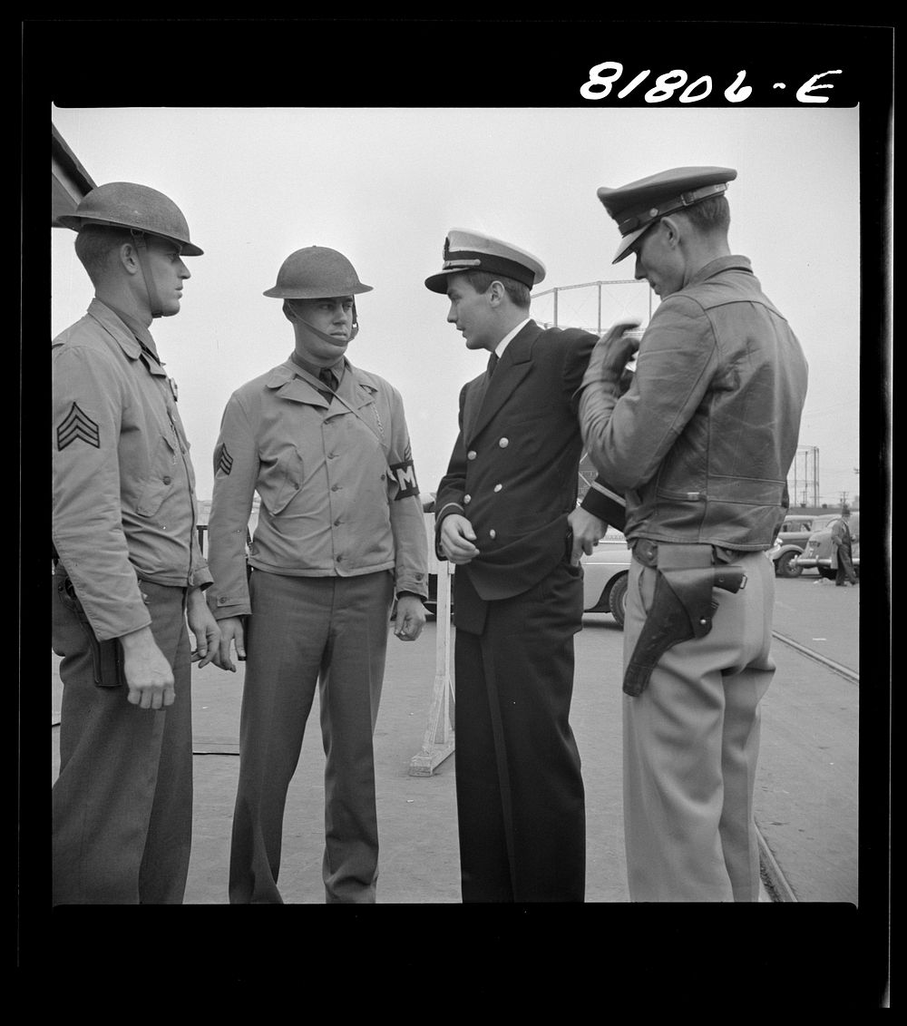 Officer of transport searching for his identification. Transport dock, San Francisco, California. Sourced from the Library…