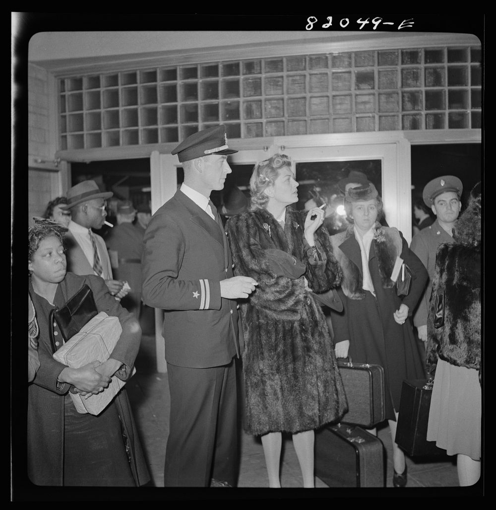 Washington, D.C. Christmas rush in the Greyhound bus terminal. Naval officer and his wife. Sourced from the Library of…