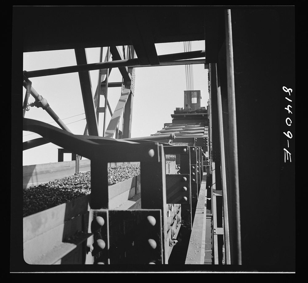 Conveyor belt carrying coal into the hole of Canadian collier at Oswego, New York. Sourced from the Library of Congress.
