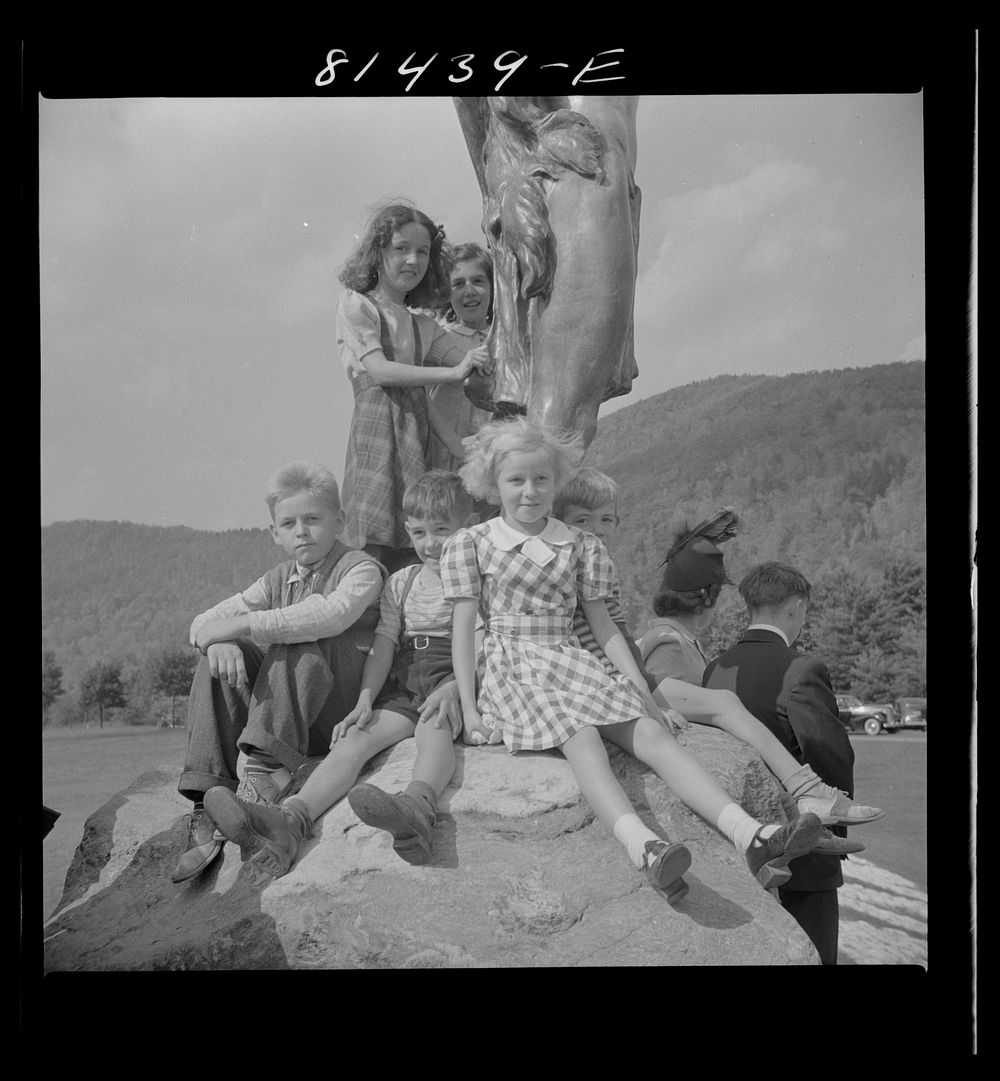 Children crowded up on the feet of "Hail to the Sunrise" bronze Indian to have their pictures taken. Mohawk Trail…