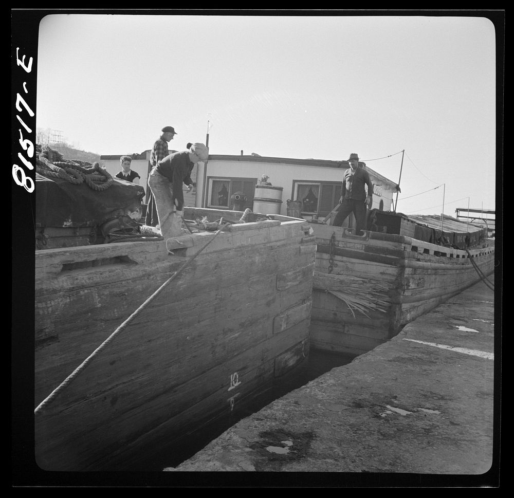 Barges being pulled through by winch, prior to picking towline from tug. Erie Canal, New York. Sourced from the Library of…