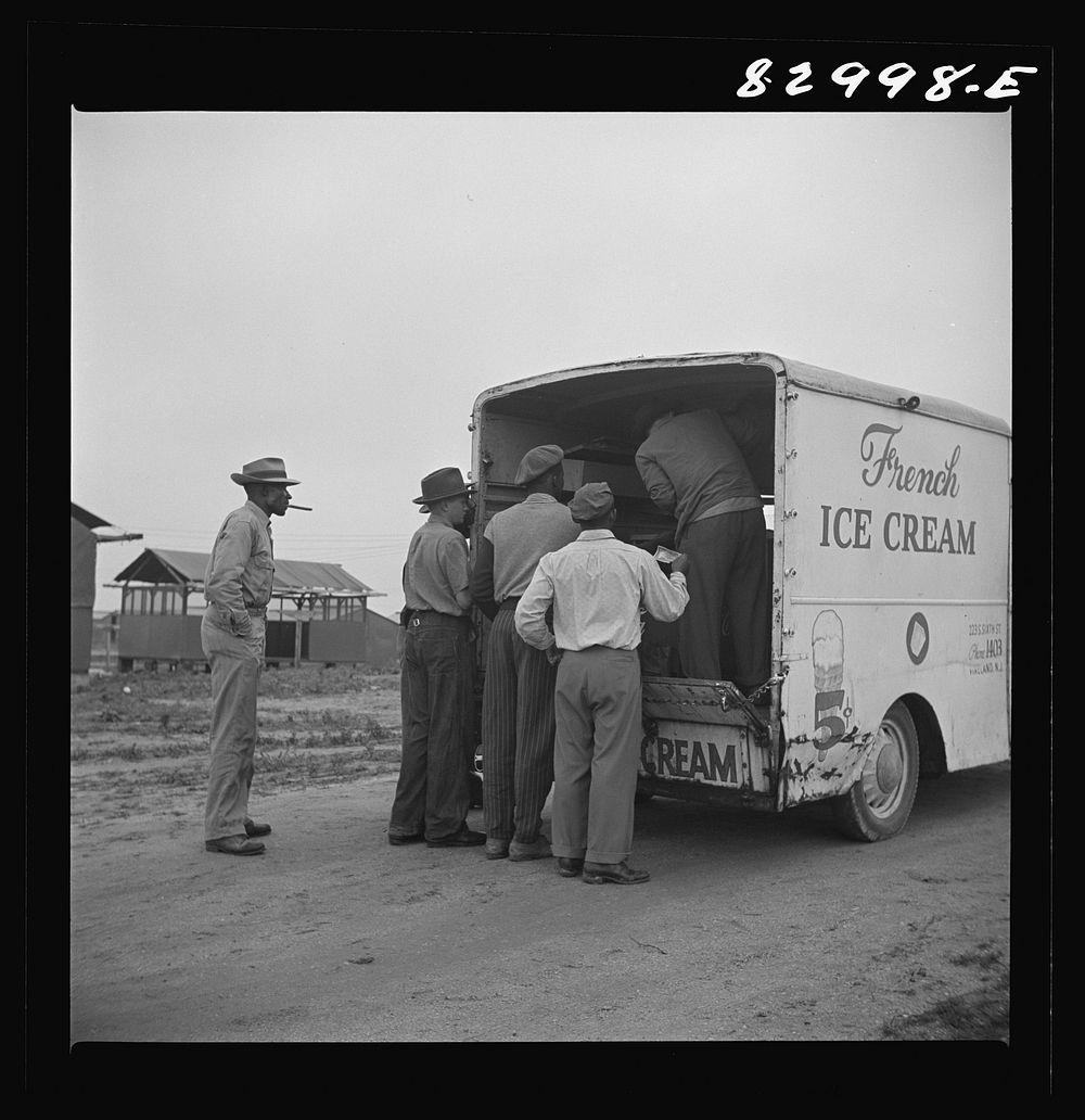 Bridgeton, New Jersey. FSA (Farm Security Administration) agricultural workers' camp. Ice cream trucks make daily trips…