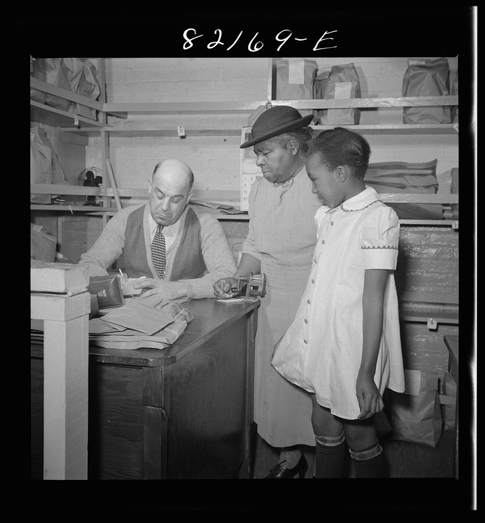 Washington, D.C. This girl's grandmother has just bought her a new dress with scrip at the self-help exchange. Sourced from…