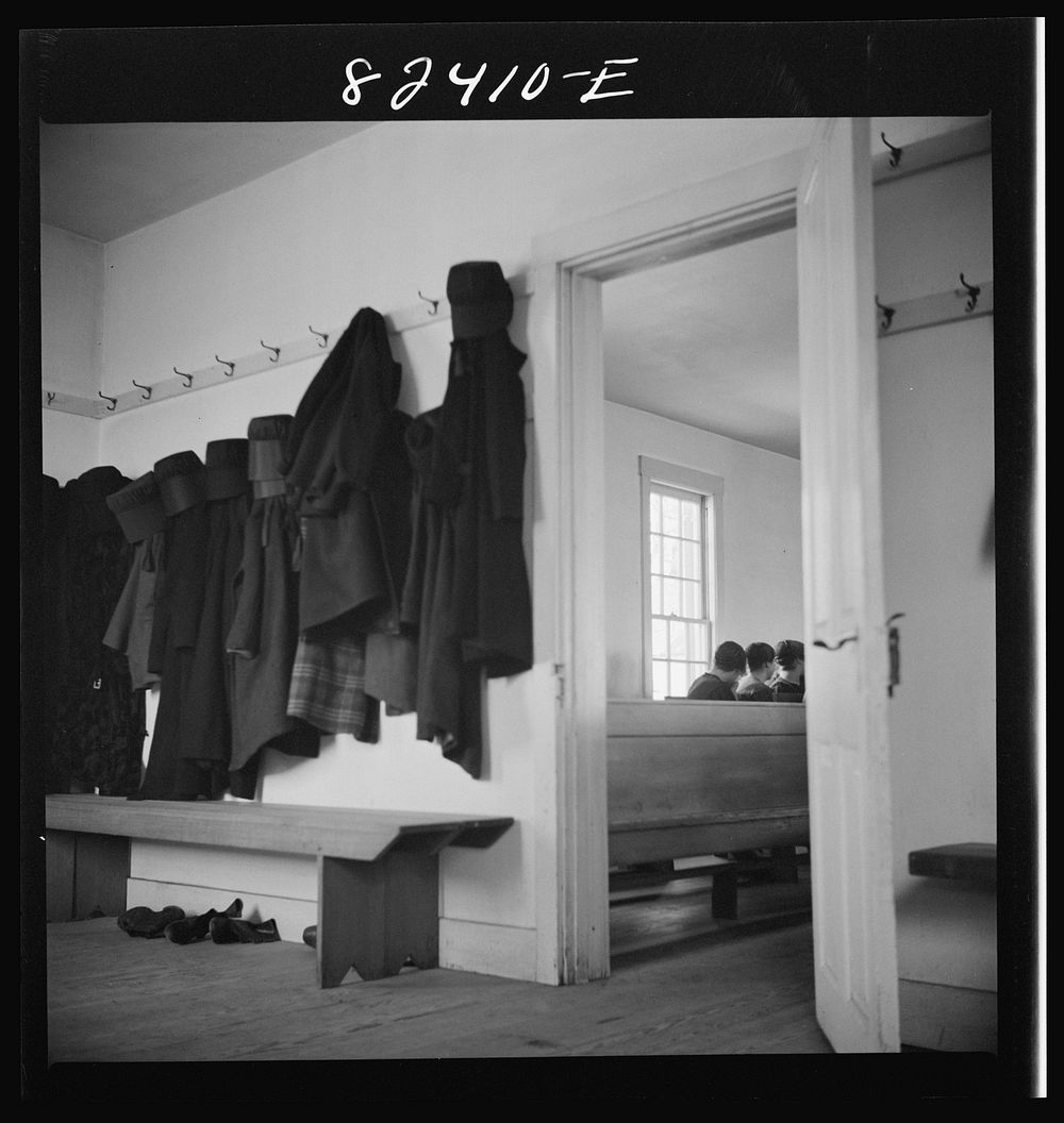 Hinkletown, Pennsylvania (vicinity). Girls' cloaks and bonnets hanging in church during "Deutsch school". Sourced from the…