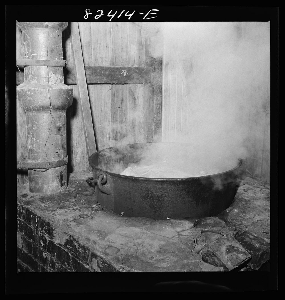 Honey Brook, Pennsylvania (vicinity). Boiling down meat scraps which remain from butchering on an Amish farm by John Collier…