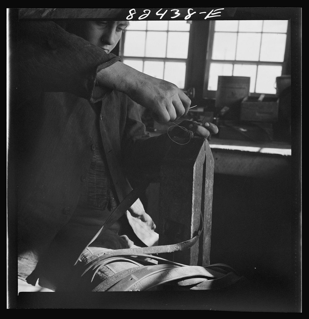 [Untitled photo, possibly related to: Honey Brook, Pennsylvania (vicinity). Amish farmhand mending harness on the Zook farm]…