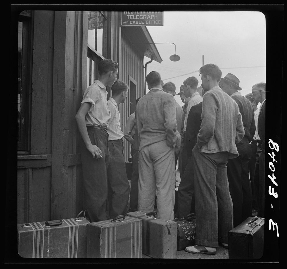 Richwood, West Virginia. Boys waiting at the station to board train for upper New York state to work in the harvest. Sourced…