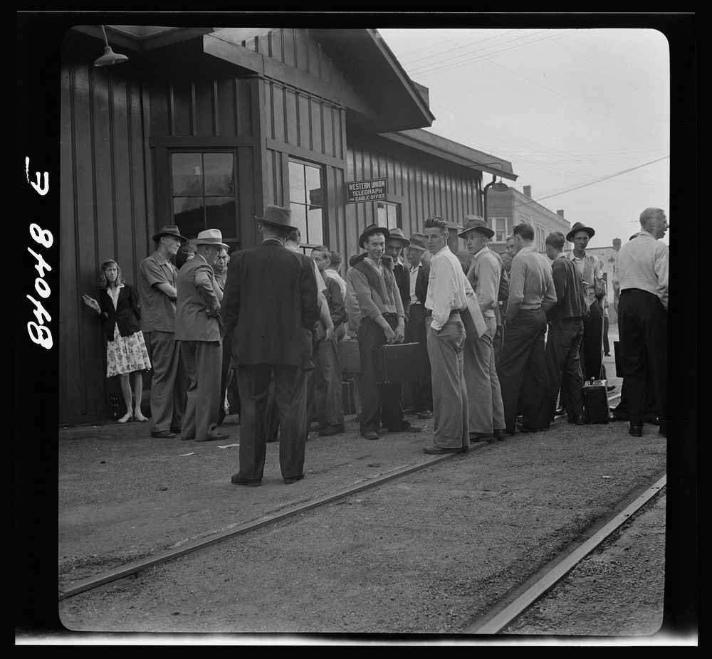 Richwood, West Virginia. Boys and girls waiting to board a train for upper New York state to help in the harvest. Sourced…
