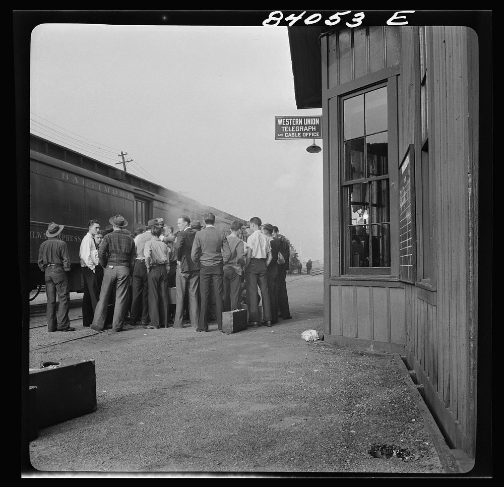 Richwood, West Virginia. Station scene at departure of men to help in the harvest in upper New York state. Sourced from the…