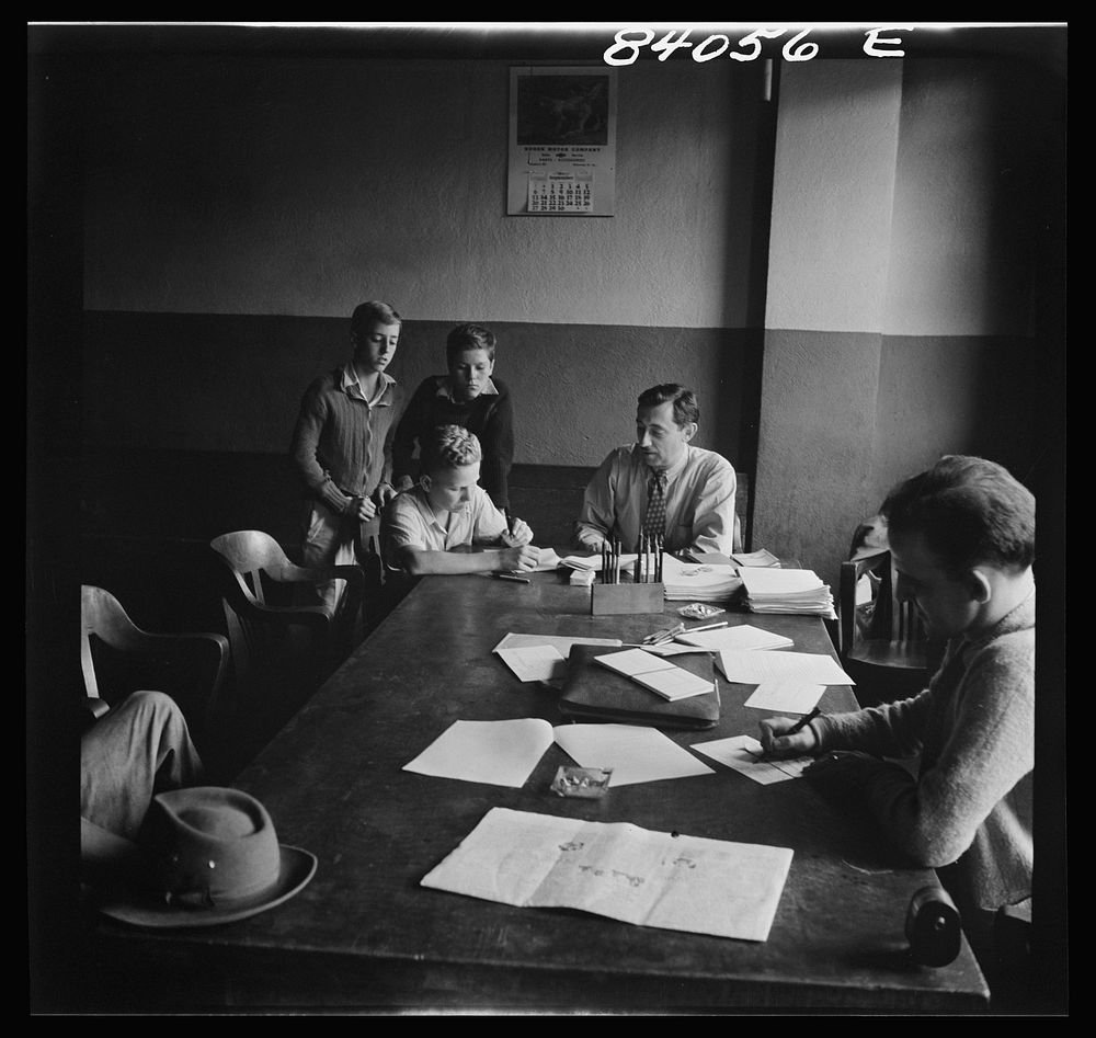 Richwood, West Virginia. FSA (Farm Security Administration) representative signing up high school boys to go by special…