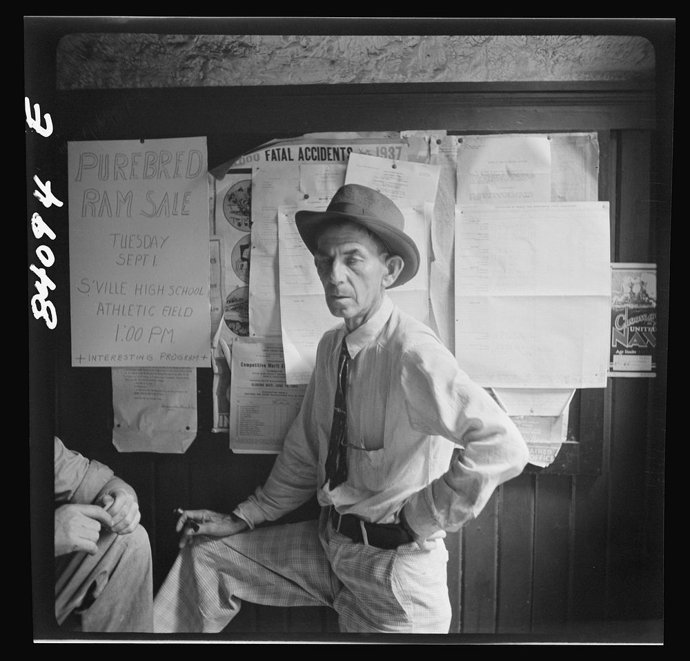 Summersville, West Virginia. Cynical citizens watching FSA (Farm Security Administration) official recruiting laborers to…