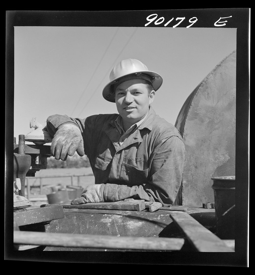 [Untitled photo, possibly related to: Elmer Womack, derrick man from Fairfax, Oklahoma overhauling mud hog where oil well is…