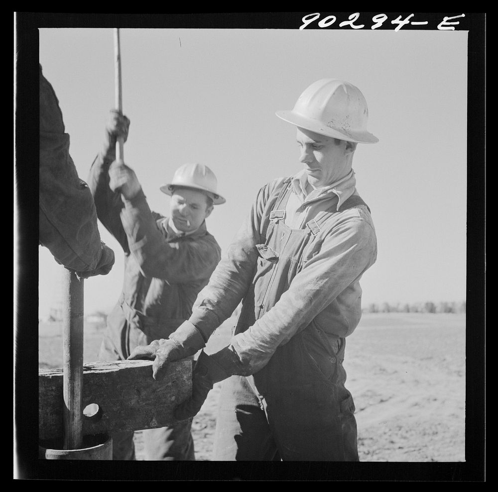 [Untitled photo, possibly related to: Oil man by new well being drilled in Goodrich field of Continental oil company. Valley…