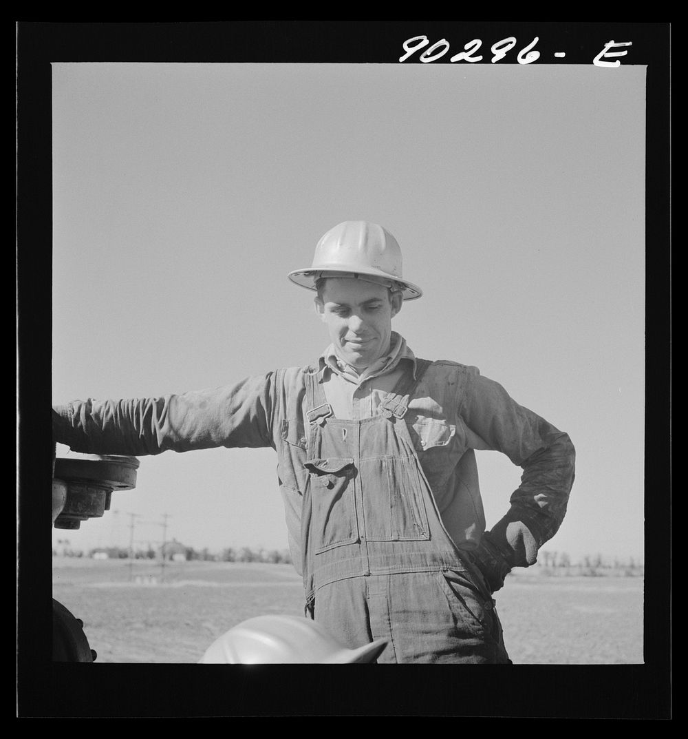 Oil man by new well being drilled in Goodrich field of Continental oil company. Valley Center oil field near Wichita…