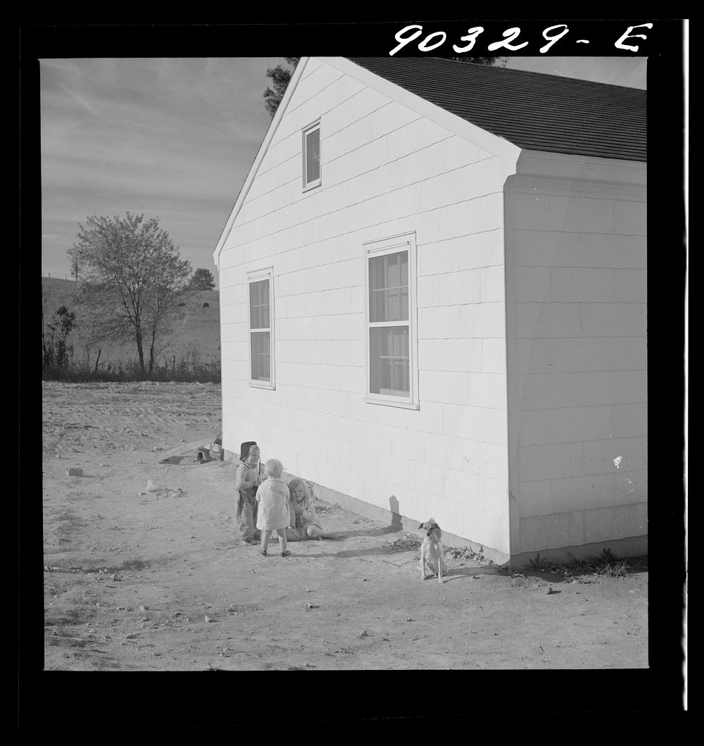 Children of defense workers playing outside their home in Sunset Village, FSA (Farm Security Administration) housing…