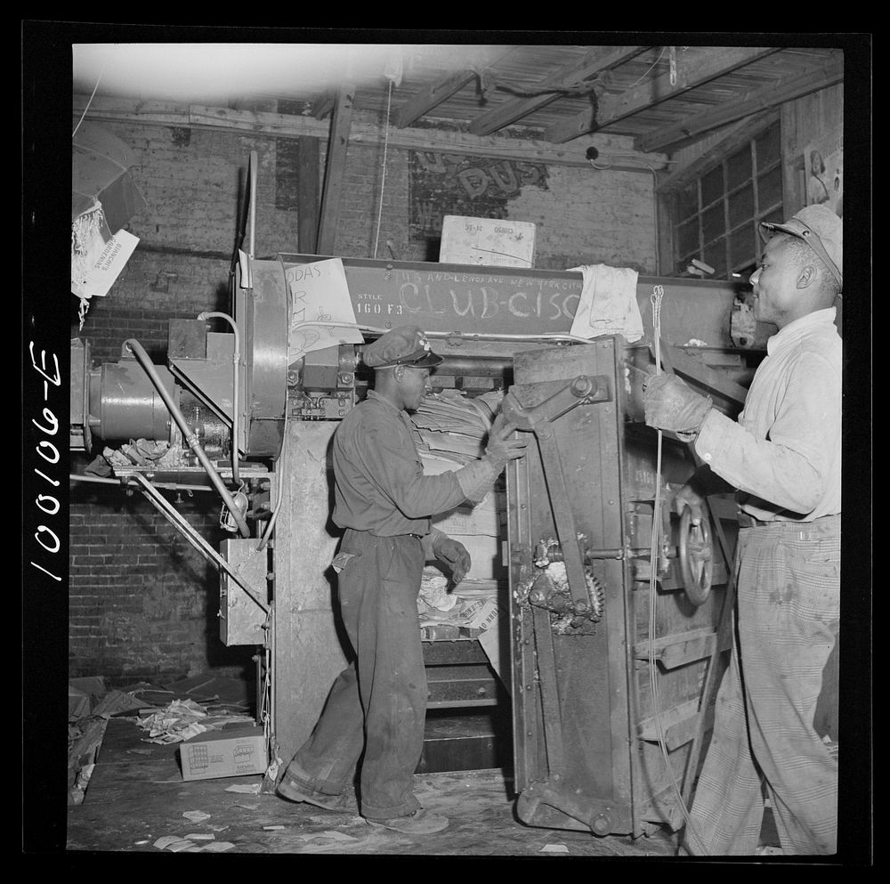 Washington, D.C. Scrap salvage campaign, Victory Program. Opening up hydraulic press showing paper ready for baling. Sourced…