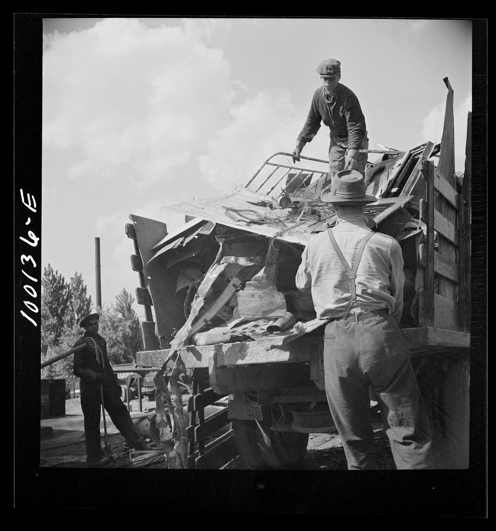 [Untitled photo, possibly related to: Washington, D.C. Scrap salvage campaign, Victory Program. Unloading metal scrap from a…