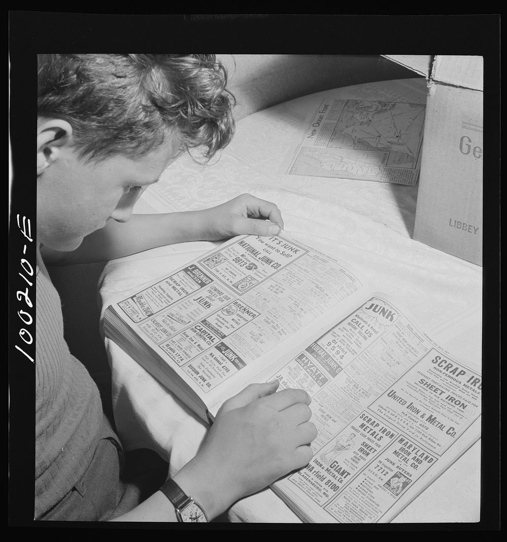 Washington, D.C. Scrap salvage campaign, Victory Program. This boy is looking up junk dealers in the telephone directory. He…