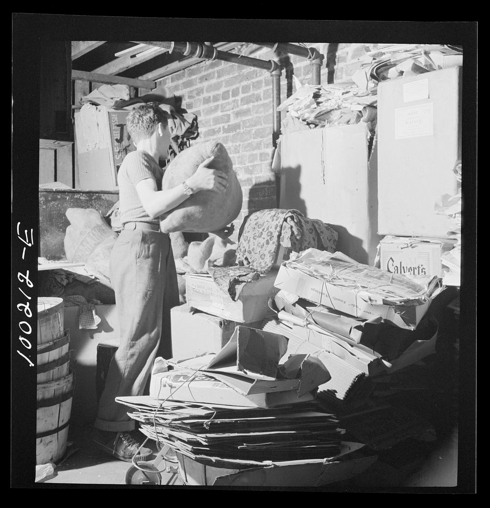 [Untitled photo, possibly related to: Washington, D.C. Scrap salvage campaign, Victory Program. This boy keeps stacks of…