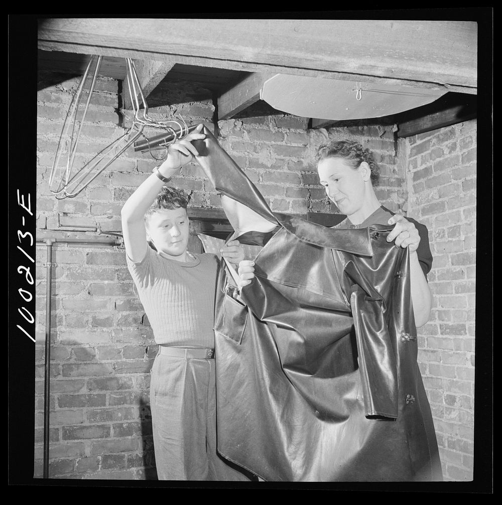 [Untitled photo, possibly related to: Washington, D.C. Scrap salvage campaign, Victory Program. Torn rubber raincoat found…