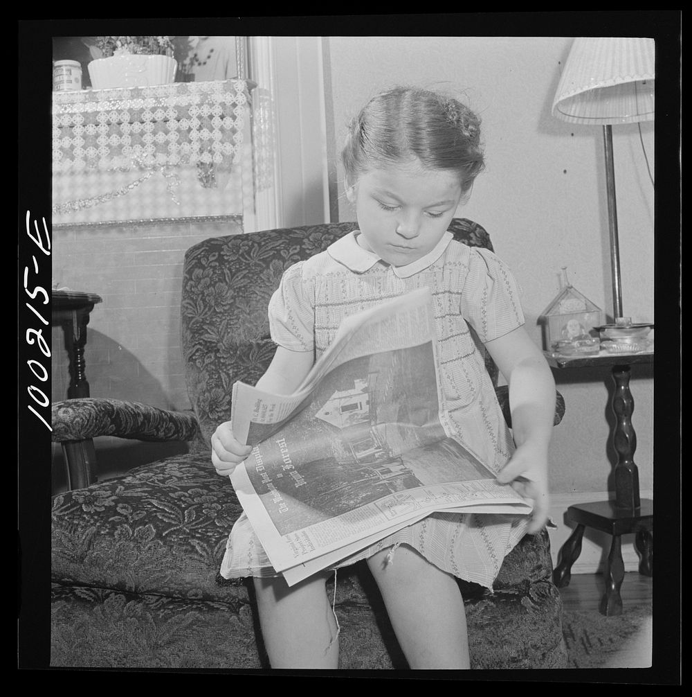 Washington, D.C. Scrap salvage campaign, Victory Program. This little girl folds the Sunday paper to take to school for…