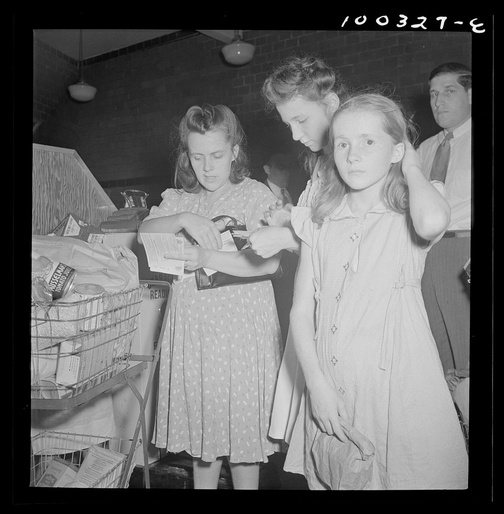Washington, D.C. Customers getting out their sugar ration cards in the Giant Food shopping center on Wisconsin Avenue.…