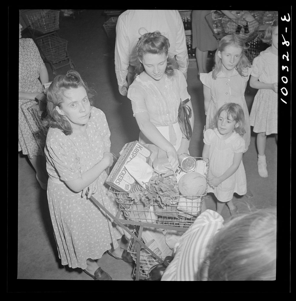 [Untitled photo, possibly related to: Washington, D.C. Customers getting out their sugar ration cards in the Giant Food…