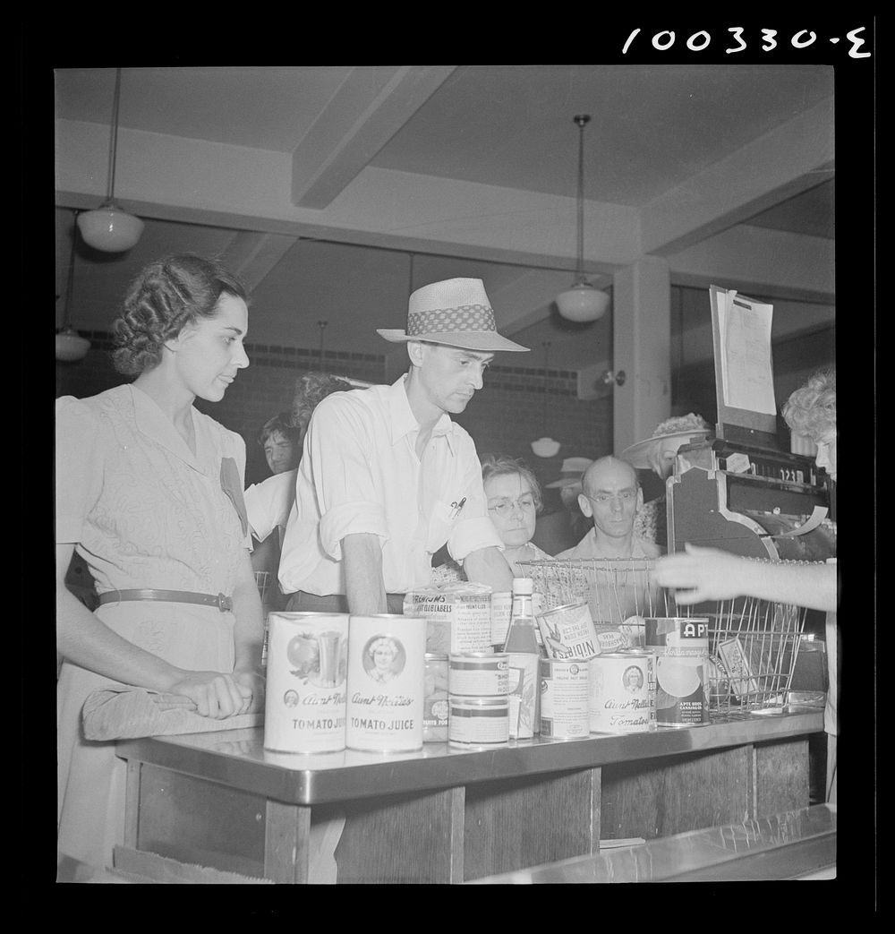 Washington, D.C. Cashier checking out a customer's purchases at the Giant Food shopping center. Sourced from the Library of…