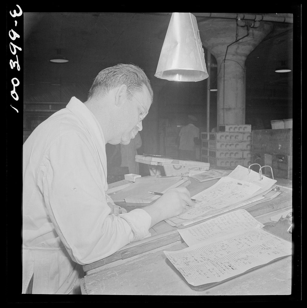 Washington, D.C. District grocery store warehouse on 4th Street S.W. Order clerk making out bills for the store owners who…